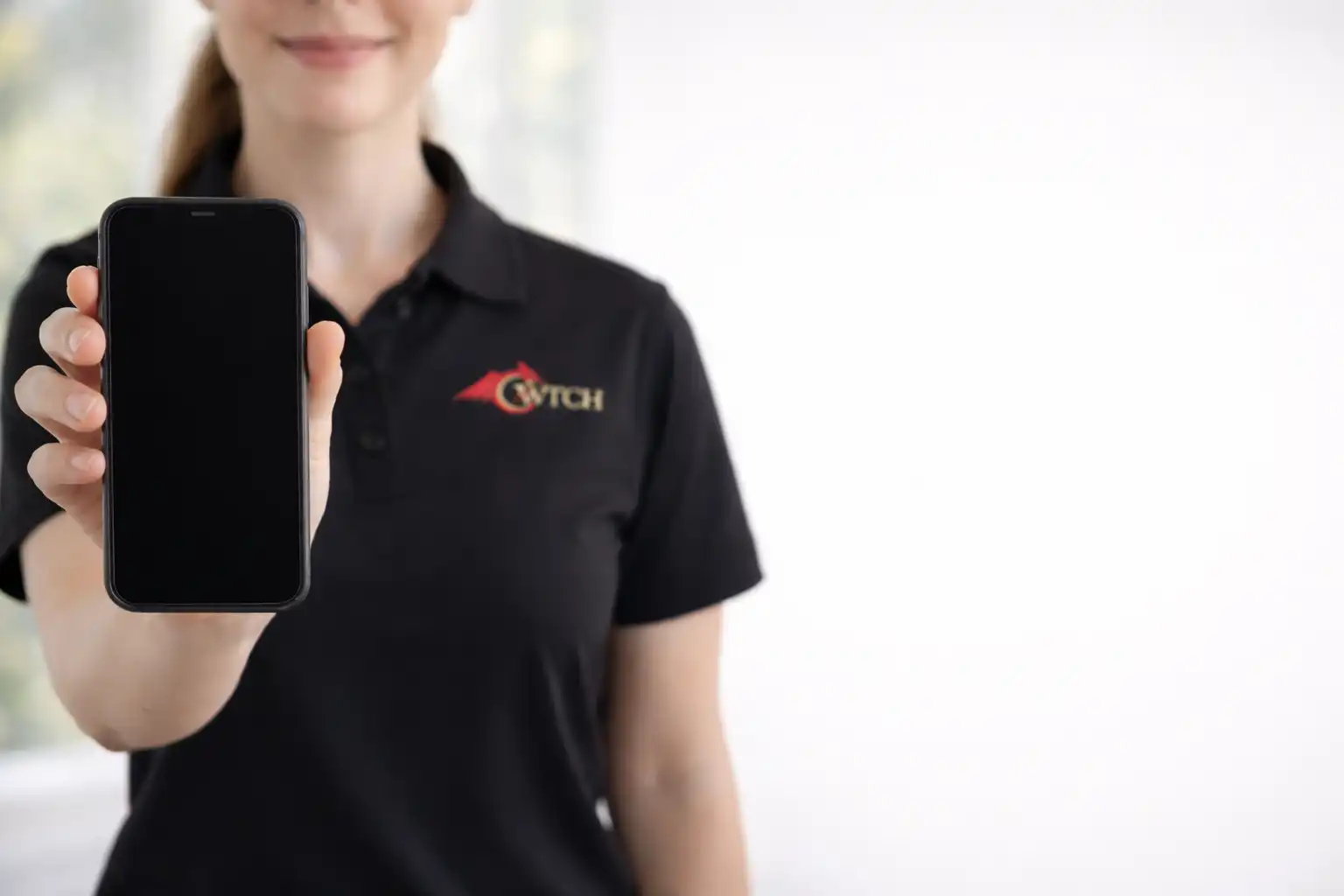 Cwtch Care carer holding out a phone, ready to take your call